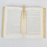 acoustic guitar bookmark shown being used in a book