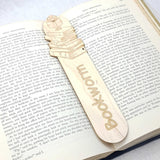 bookworm wooden bookmark shown in a book