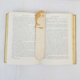 dolphin bookmark shown being used in a book
