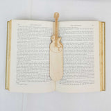 electric guitar bookmark shown being used in a book