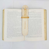 lighthouse bookmark shown being used in a book