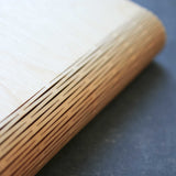 wooden notebook cover showing the living hinge flexible spine