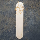 Music wooden bookmark with musical notes curving around from a treble clef