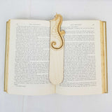 seahorse bookmark sown being used in a book