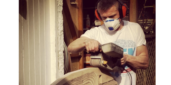 image of Jim sanding and shaping a surfboard chair