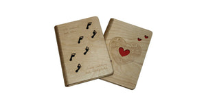Image of 2 A5 sized wooden notebook covers, one with a footprint design the other with a heart design.