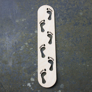 Wooden bookmark with a footprints design