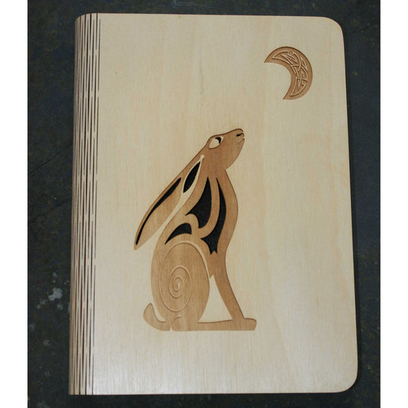 wooden note book cover with a hare and moon design