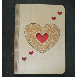 wooden note book cover with a heart design