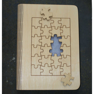 wooden note book cover with a jigsaw puzzle design