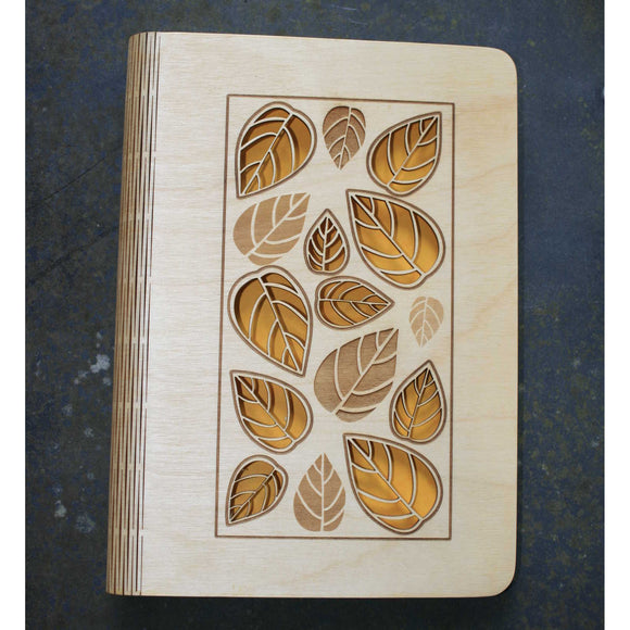 wooden note book cover with a leaves design