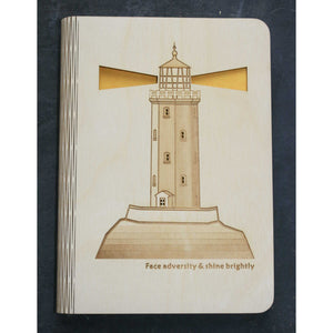 wooden note book cover with a lighthouse design