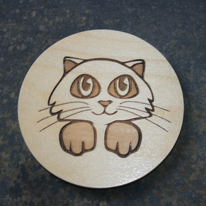Wooden coaster with a cat head design