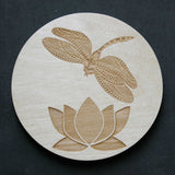 Wooden coaster with a dragonfly and lily design
