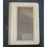 wooden note book cover with a round lattice design