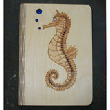 wooden note book cover with a seahorse design
