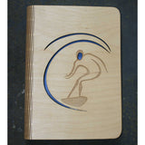 wooden note book cover with a surfer on a wave design