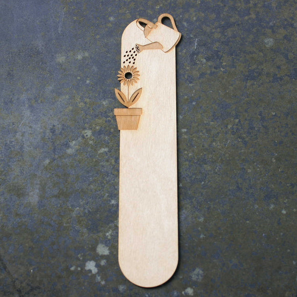 Wooden bookmark with a watering flowers design