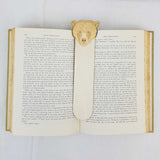 Bear wooden bookmark being shown in a book