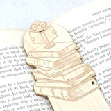 close up of the bookworm bookmark detail showing the worm reading a book on top of a stack of books