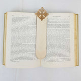 Celtic quad-knot bookmark shown being used in a book