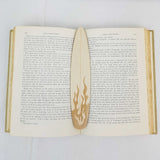 fire surfboard bookmark shown being used in a book