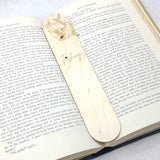 Fishing bookmark shown being used in a book