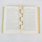 footprints bookmark shown being used in a book