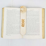 lion bookmark shown being used in a book