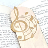 Close up of the details of the music wooden bookmark showing the notes curling away from a treble clef