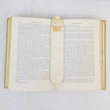 seal head bookmark shown being used in a book