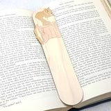 Squirrel wooden bookmark shown being used in a book