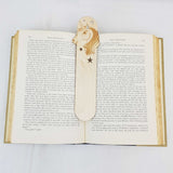 unicorn bookmark shown being used in a book